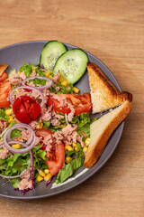 Canned tuna salad with letuce and fresh vegetables, top view