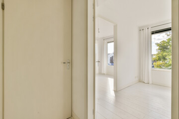 An inviting modern interior space featuring a bright window view and elegant minimalist design, showcasing clean lines and spaciousness.