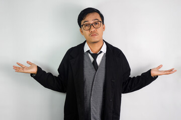 Asian man wearing a mafia-like suit and wearing glasses, making a shrugging gesture symbolizing he doesn't know