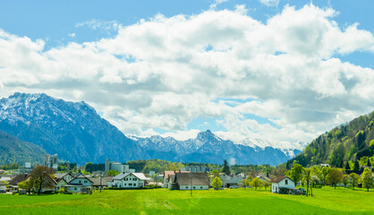 Fototapeta premium Beautiful landscape of snow mountain and grassland scenery in St. Wolfgang, Salzburg, Austria, shot in early May
