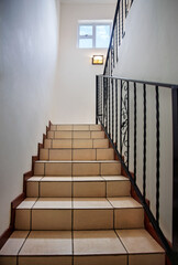 interior staircase with forged iron balustrade, tiled stairs and floor, manufacturer of forged iron...