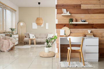 Interior of studio apartment with workplace, sofa and armchair