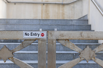 No entry sign on stainless steel gate.