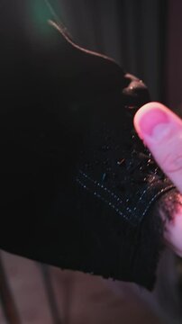 A master sews national Arab clothes abay with a needle and thread in his atelier