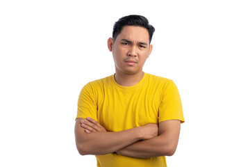 Handsome Asian young man keeping arms folded and looking at camera with skeptical expression isolated on transparent background