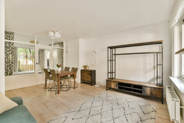 An elegantly designed modern living room featuring a dining area, minimalist furniture, and natural light, creating a cozy and inviting atmosphere.