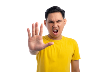 Frustrated young Asian man standing with outstretched hand showing stop gesture isolated on transparent background