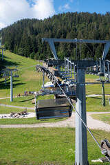 Summer Chairlift in Fai della Paganella – Alpine Transport with Blue Sky and Green Meadows