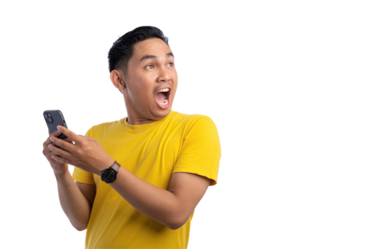 Surprised young Asian man using smartphone and looking aside at copy space isolated on transparent background