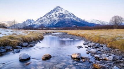 Winter mountain stream reflecting snow-capped peak.  Tranquil alpine landscape