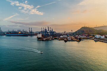 A view from a ship towards a port at the Panama Canal entrance in Panama at sunrise in springtime