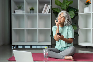 Wellness and Mindfulness. A senior woman engaging in daily wellness practices while enjoying a moment of reflection with her phone.