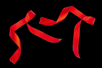 Delicate Red Wavy Ribbon Isolated on a black Background. 