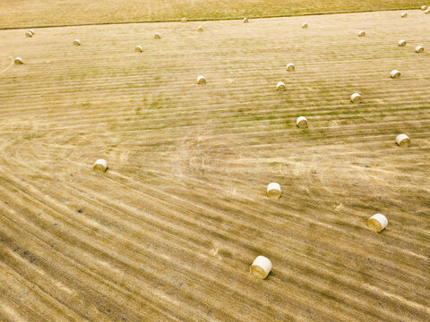 Aerial view of round hay bales in a dry paddock
