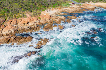 Aerial view of waves crashing on a rocky coastline