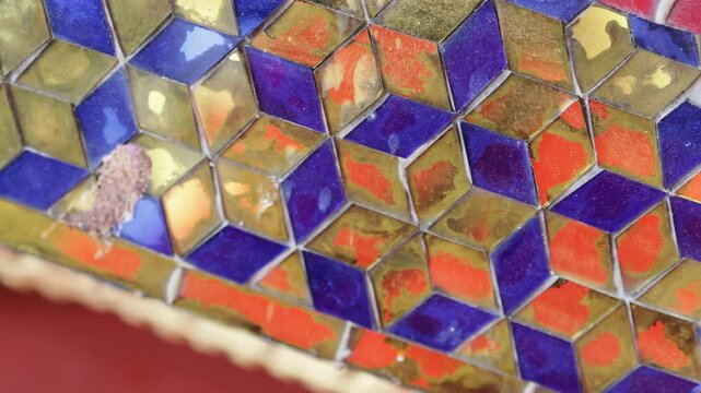Blue with gold mosaic pattern in wall.