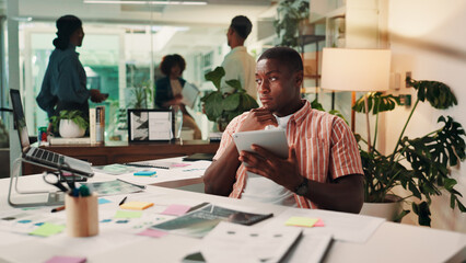 Businessman, web designer and thinking with laptop for project design, idea or improvement at office desk. Man, creative employee or developer with technology, tablet or documents for schedule tasks