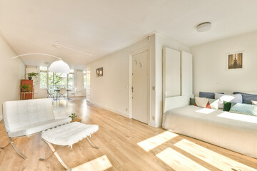 Bright and airy interior of a modern living space featuring white furniture, natural light, and minimalist design elements. A tranquil and inviting atmosphere.
