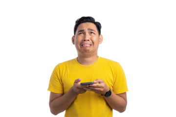 Worried young Asian man holding mobile phone and looking up with sad expression isolated on transparent background