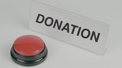 "Donation" text or word displayed on a nameplate as a hand presses a red button, set against a white background, symbolizing generosity, giving, and a call to contribute