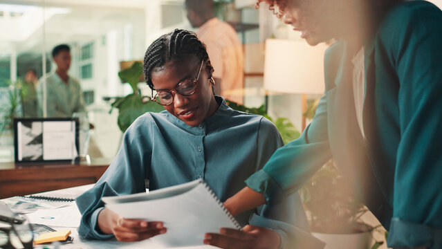 Teamwork, business people and women in office, documents and feedback for sales report. Employees, conversation and manager in workplace, advice and review for proposal, questions and cooperation