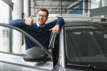 Handsome bearded buyer in casual wear in dealership