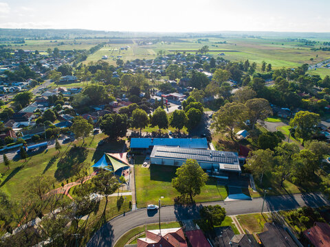 Aerial view of Singleton Visitor Information Centre and park in country town on sunlit morning