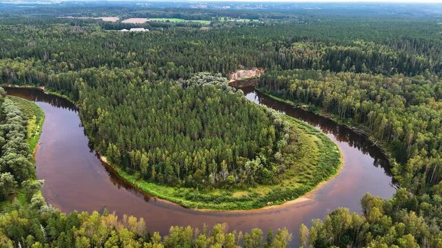 Aerial view of Ancient Sandstone Cliffs (Erglu Klintis) and Devonian Rock Formations Along a River Valley in Gauja National Park, Latvia