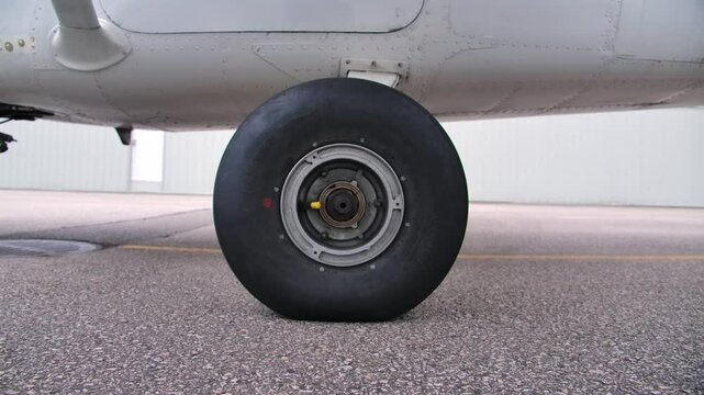 Close Up Wheel and Tire of Landing Gear of Light Airplane - Dolly Out