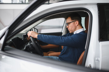 New car, dealership and portrait of happy man in vehicle for purchase, good service or loan success