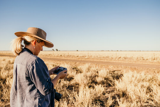 Female flying drone in rural Australia