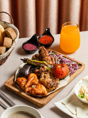 Kebab assortment in wooden plate. Lamb kebab, lula kebab, chicken kebab and vegetables kebab