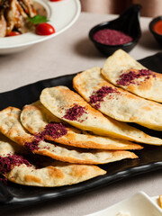 Azerbaijani stuffed flatbread - Qutab on black tray