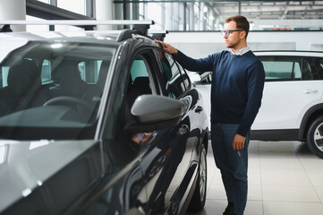 Man buying a car at a showroom
