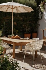 A white umbrella is shading a table with a bowl of fruit and a vase of flowers