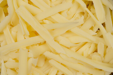 The image shows a close-up of shredded Gouda cheese