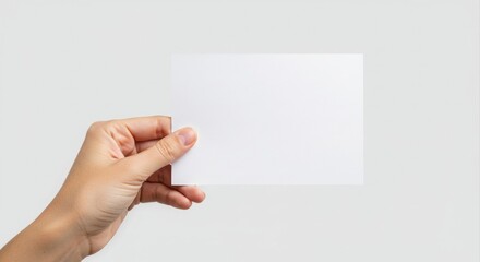 Fototapeta premium Hand holding blank white paper.