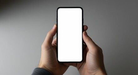 Hands holding a smartphone with blank screen.