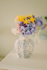 Blue Grape Hyacinths in a Transparent Glass Vase on Neutral Background