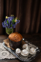 Traditional Easter Cake and White Eggs with Gold Leaf on Rustic Table with Spring Flowers