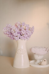 Pastel Spring Flowers in Elegant Ceramic Vase on Light Background