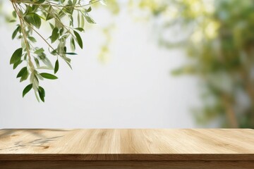 Natural wooden table with hanging green leaves and soft blurred garden background, perfect minimal mockup for organic product display, branding, packaging, or summer presentation