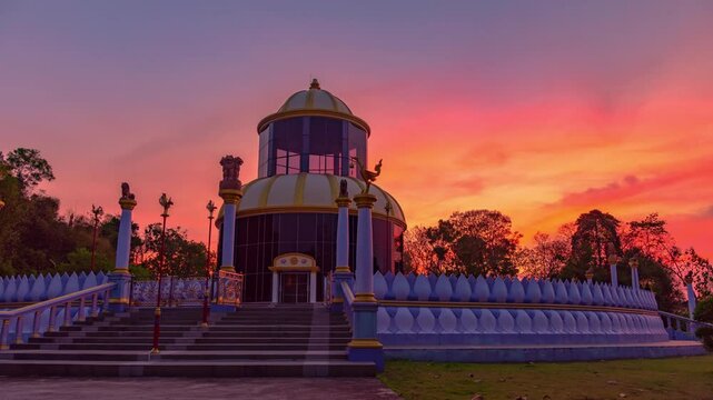 Time lapse amazing pink sky at sunset behind the beautiful pagoda of wat Khao Kog beside Cadet Academy Nakhon Nayok Thailand. The dome-shaped pagoda, modeled after one from India