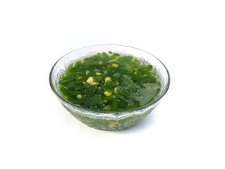 Moringa leaves with corn soup in bowl isolated on white background, high angle view 