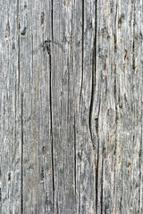 Close-up view of aged, weathered wood with intricate grooves and patterns emphasizing its rustic charm in natural light.