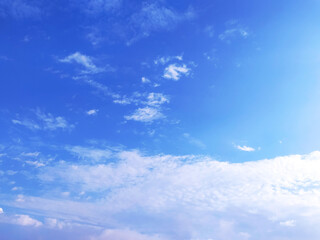 Fototapeta premium Clear blue sky texture and white fluffy cloud nature background. The sun shines bright in the daytime in summer
