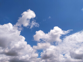 Clear blue sky texture and white fluffy cloud nature background. The sun shines bright in the daytime in summer
