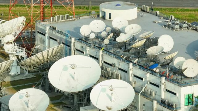 The scene features a satellite ground station with large, rotating dishes designed to capture satellite data, forming a backbone of modern communication systems.
