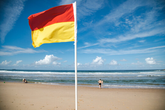 Lifeguard flag flying on patrolled beach at Coffs Harbour, NSW on sunny day