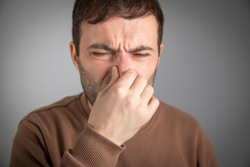 Fototapeta premium Caucasian man disgusted expression for stink.